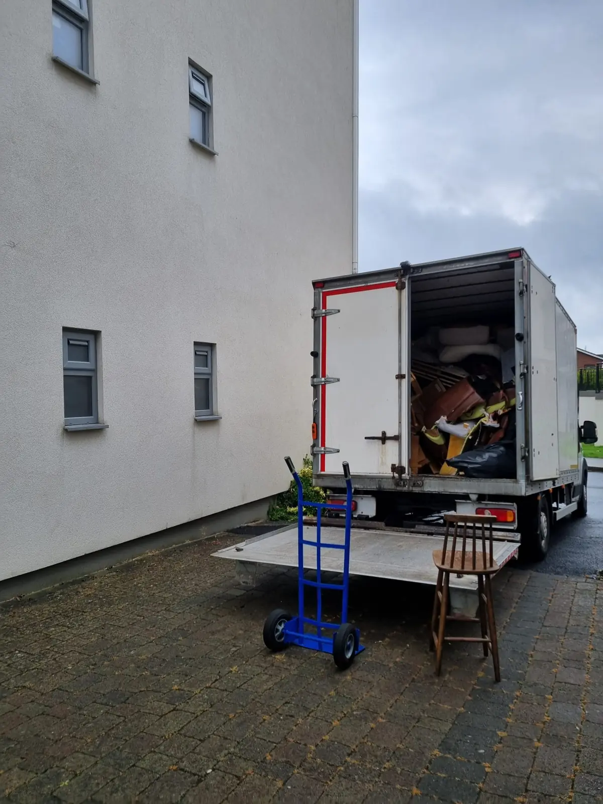 Truck being loaded outside an apartment block during a clearance