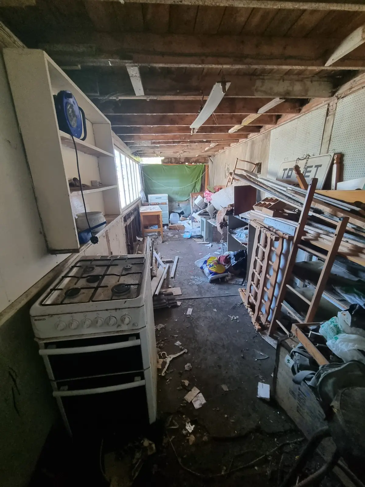 Cluttered shed interior before a shed clearance