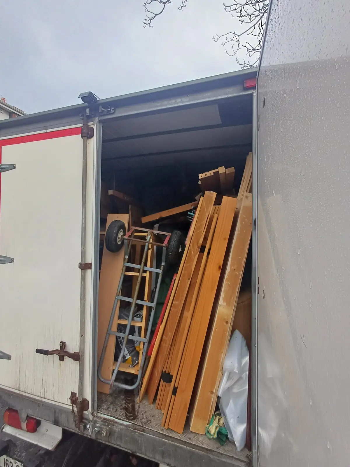 Timber and pallets loaded into a truck during a warehouse clearance